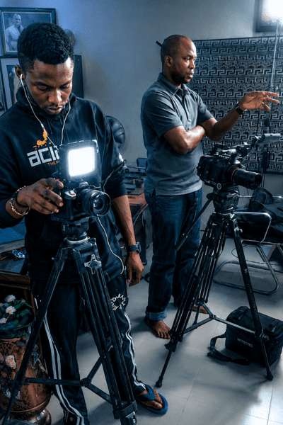 Professional video production team setting up cameras and lighting equipment for cinematic content creation at Workplace Digital Services